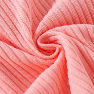 Close-up of pink ribbed knit fabric texture showing elasticity and soft texture details