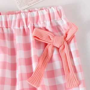 Detail of pink plaid pants for girls featuring an elastic waist and ribbed bow detail