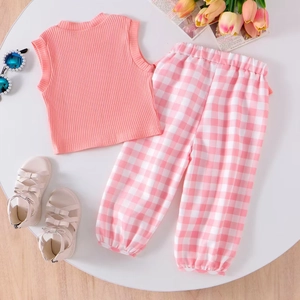 Flat lay of pink ribbed tank top and pink gingham pants for girls summer casual wear