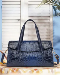Vue détaillée du sac cabas bleu foncé à texture crocodile avec boucles métalliques