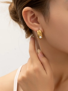 Vue détaillée des boucles d'oreilles créoles dorées avec perles sur mannequin doré 18k