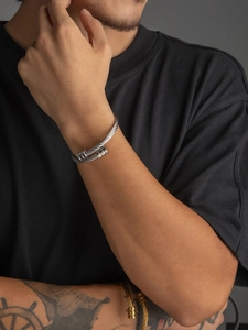 Macro shot of silver cable textured nail bracelet made of durable titanium steel