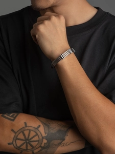 Detail of silver triple-strand braided stainless steel cable bracelet on model wrist