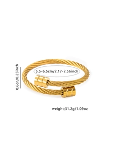 Detail of gold-plated twisted cable bracelet with adjustable opening and engraved end caps