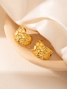 Détail de boucles d'oreilles en C plaquées or 18 carats avec texture de lave martelée