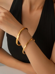 Close-up of stylish 18K gold plated hammered texture rhombus bangle for women