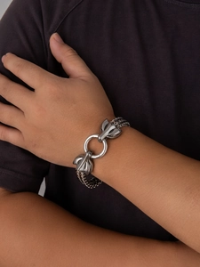 Close-up of a Viking wolf head bracelet in silver stainless steel with mesh chain on wrist