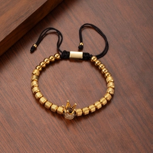 Adjustable golden beaded bracelet with crown charm and textured mesh metal beads