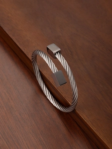 Macro shot of twisted stainless steel wire bangle with polished rectangular end caps