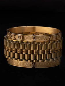 Macro view of 18k gold plated stainless steel cuff set with Roman numeral engravings
