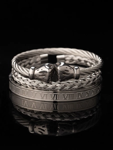 Detail of three-piece silver stainless steel men's bracelets with Roman numerals engraving