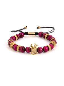 Macro detail of crown charm on rose red tiger eye stone beaded adjustable bracelet