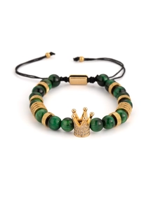 Detail of adjustable green stone bracelet with golden crown and braided black cord