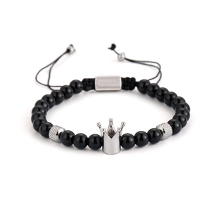 Adjustable black bead bracelet with silver crown charm and woven knot closure