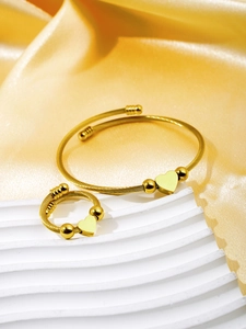 Detailed view of 18k gold plated stainless steel heart bangle and matching ring set