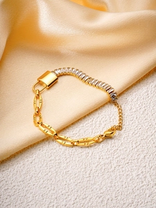Detail of gold zircon bracelet with padlock charm and rectangular crystal chain