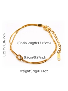 Détail du bracelet serpent en acier doré avec nœud central et mesures de taille