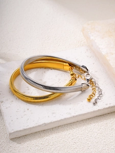 Close-up of 18k gold and silver flexible snake chain bracelets with adjustable lobster clasp
