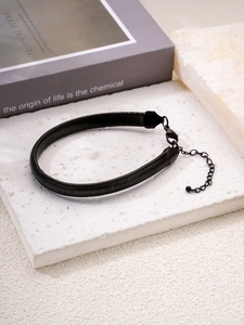 Detail of black textured snake chain bracelet with adjustable clasp and 18k gold plating