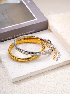 Detail of 18k gold and silver plated flexible snake chain bracelets with lobster clasps