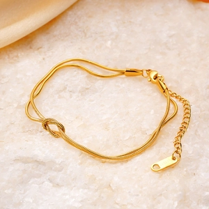 Bracelet double chaîne serpent minimaliste avec nœud central en acier inoxydable doré