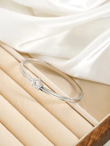 Détail du bracelet jonc étoile en argent serti de diamants sur présentoir velours