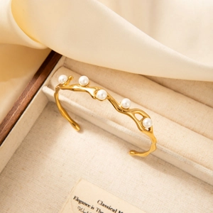 18k gold plated stainless steel wave bangle with pearls on cream satin display