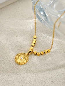 Détail du collier plaqué or 18 carats avec pendentif soleil et incrustation de perle