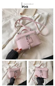 Pink crossbody bag with crocodile embossed texture and elegant silver zipper details