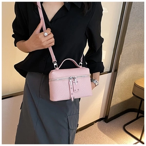 Pink heart-textured leather vanity case bag with silver hardware and shoulder strap