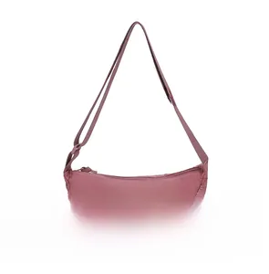 Detail of dusty rose nylon crescent bag with adjustable wide shoulder strap