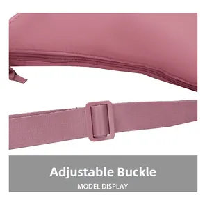 Detail view of the pink nylon crossbody bag showing the adjustable buckle and smooth zipper