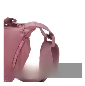 Detail of pink nylon dumpling bag showing high-quality zipper and durable strap buckle