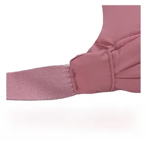 Close-up of reinforced stitching on pink nylon crossbody bag for durability