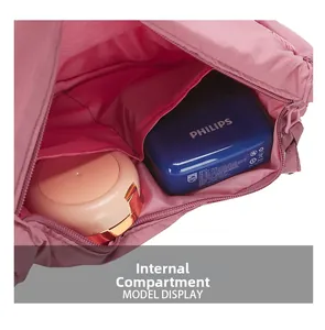 Detail view of pink nylon dumpling bag showing internal compartments and storage capacity