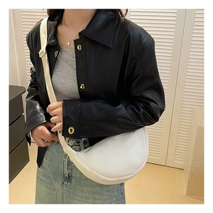 Detail of white nylon crescent bag with adjustable shoulder strap on a model