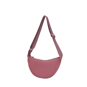 Detail of dusty rose crescent bag in nylon with adjustable strap and smooth matte finish