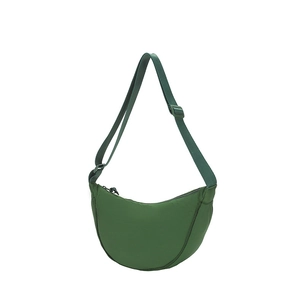 Detail view of dark green nylon crescent bag with adjustable wide strap and zipper closure