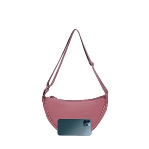 Pink crescent nylon bag shown next to a smartphone for size reference and scale