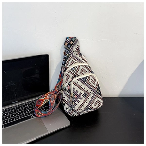 Detailed close-up of bohemian geometric woven mini chest bag with wide jacquard strap