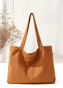 Detail view of a large capacity caramel canvas tote bag with dual shoulder straps