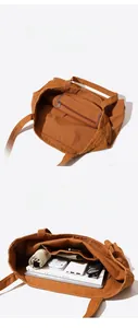 Detail view of large brown canvas tote bag interior with multi-compartment storage space