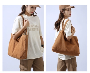Detailed side and back view of a large brown canvas tote bag on a model in casual style