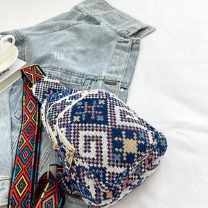 Bohemian style blue and white plaid chest bag with ethnic pattern strap on white fabric