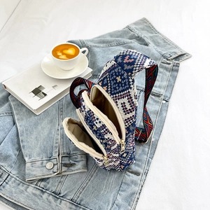 Women's woven chest bag with ethnic patterns and colorful wide strap on denim jacket