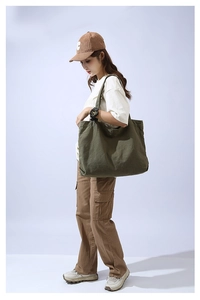 Army green large canvas tote bag showing the casual shoulder carry style for women