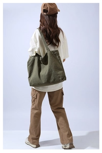 Olive green large canvas tote bag shown with a minimalist street style outfit