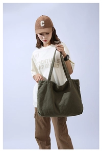 Close-up of army green canvas tote bag showing large capacity and durable material