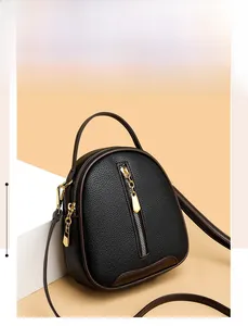 Detail of black lychee grain leather bucket bag with gold zipper and stylish handle