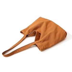 Minimalist caramel brown canvas tote bag with thick texture and shoulder strap